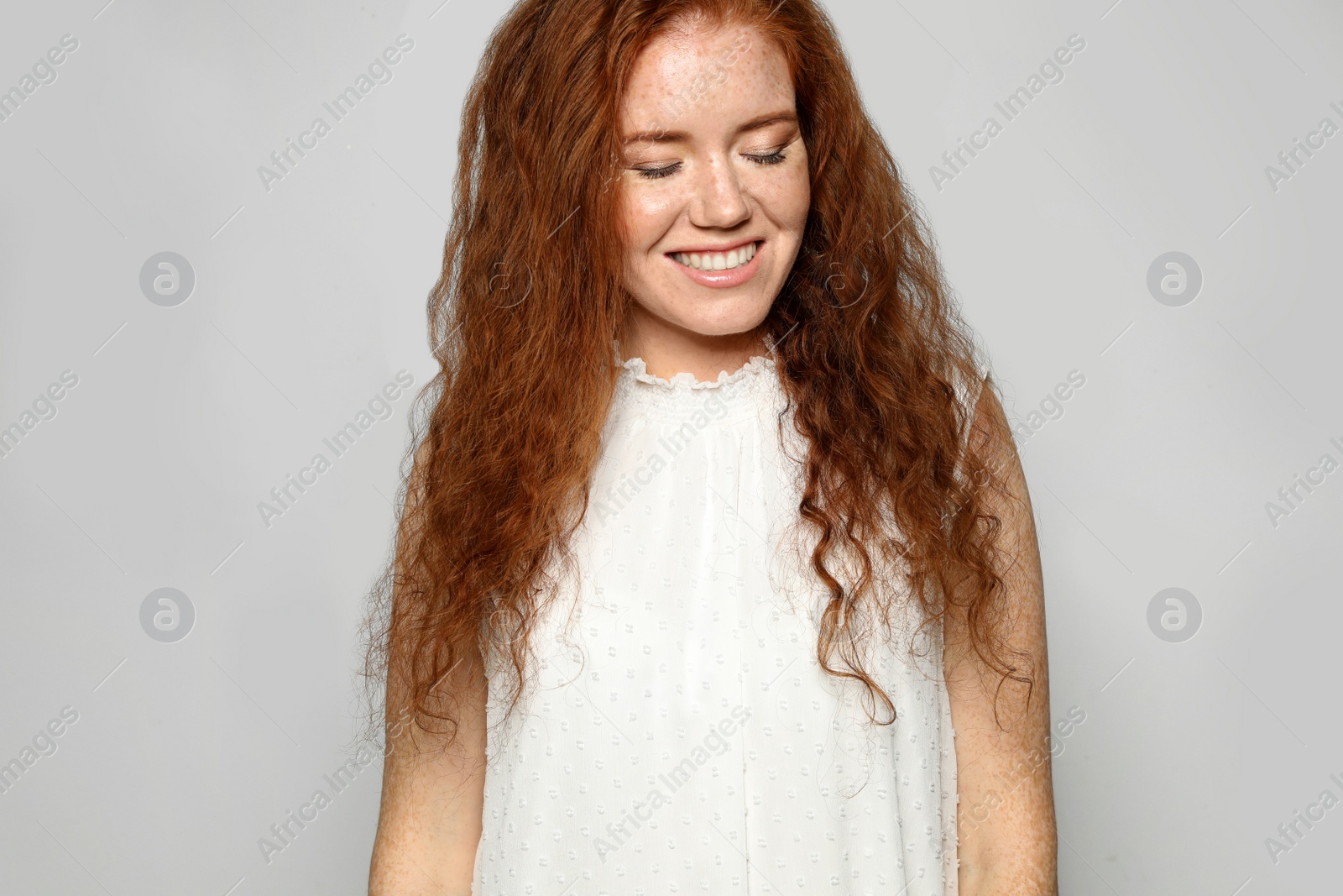 Photo of Portrait of young woman with beautiful face on grey background