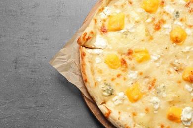 Hot cheese pizza Margherita on grey background, top view. Space for text