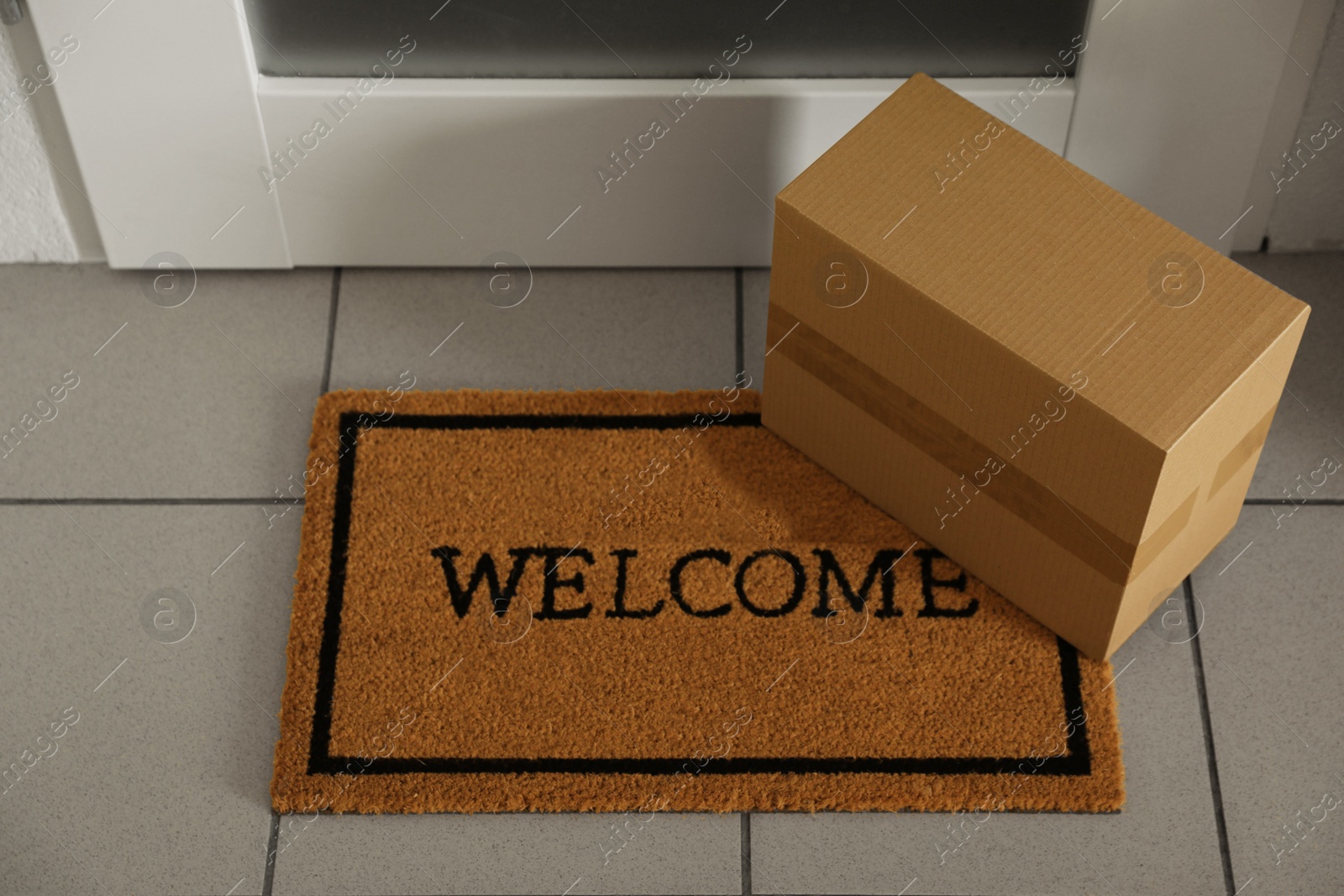 Photo of Parcel delivered on mat near front door