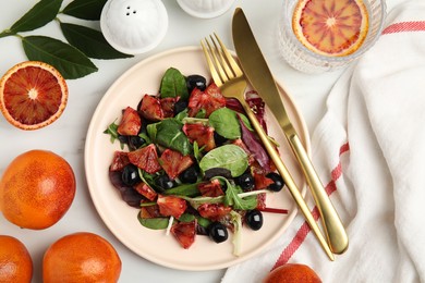 Photo of Delicious salad with sicilian orange served on white table, flat lay