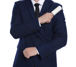 Man cleaning suit with lint roller on white background, closeup