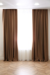 Window with elegant curtains in modern room