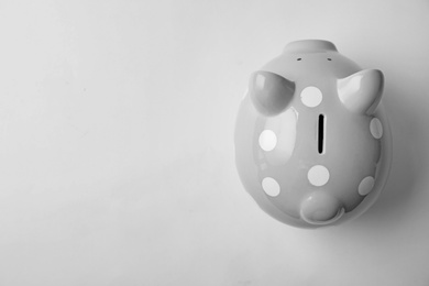Photo of Cute piggy bank on white background, top view