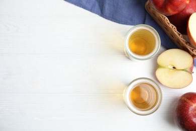 Flat lay composition with delicious apple cider on white table. Space for text