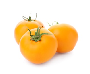 Delicious ripe orange tomatoes on white background