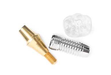 Photo of Parts of dental implant on white background, top view
