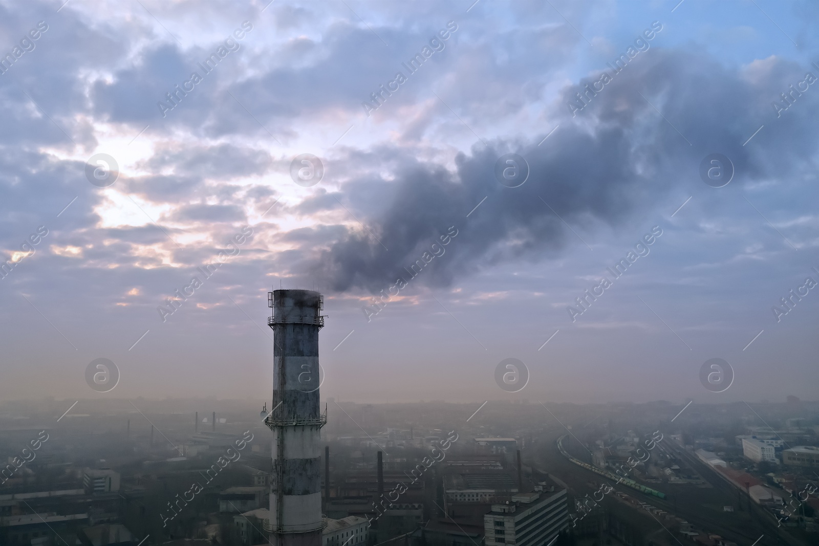 Image of CO2 emissions. Polluting air with smoke from industrial chimney outdoors, aerial view