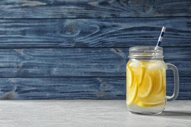 Photo of Natural lemonade with ice in mason jar on table