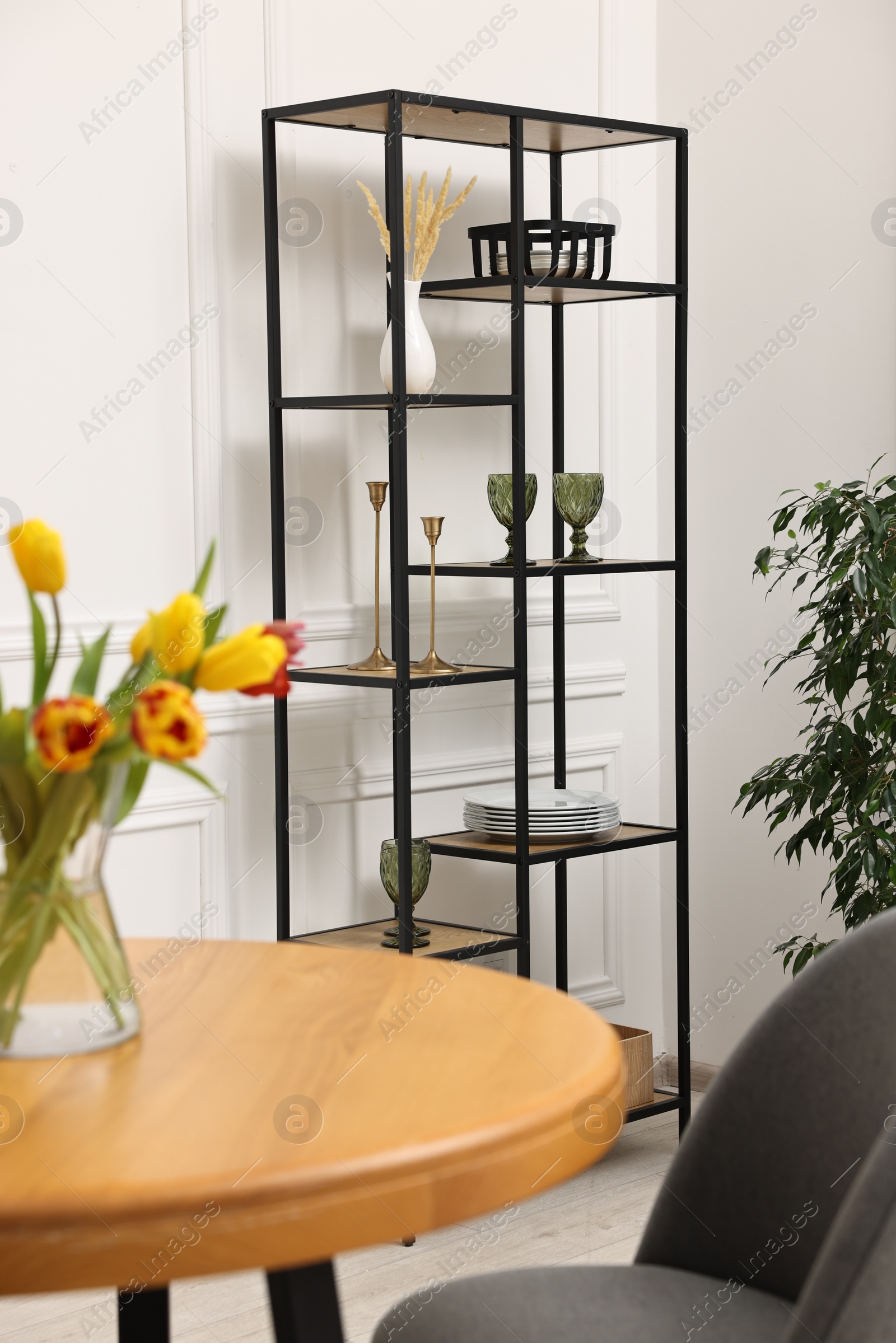 Photo of Vase with beautiful tulips on table in dining room