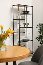 Photo of Vase with beautiful tulips on table in dining room