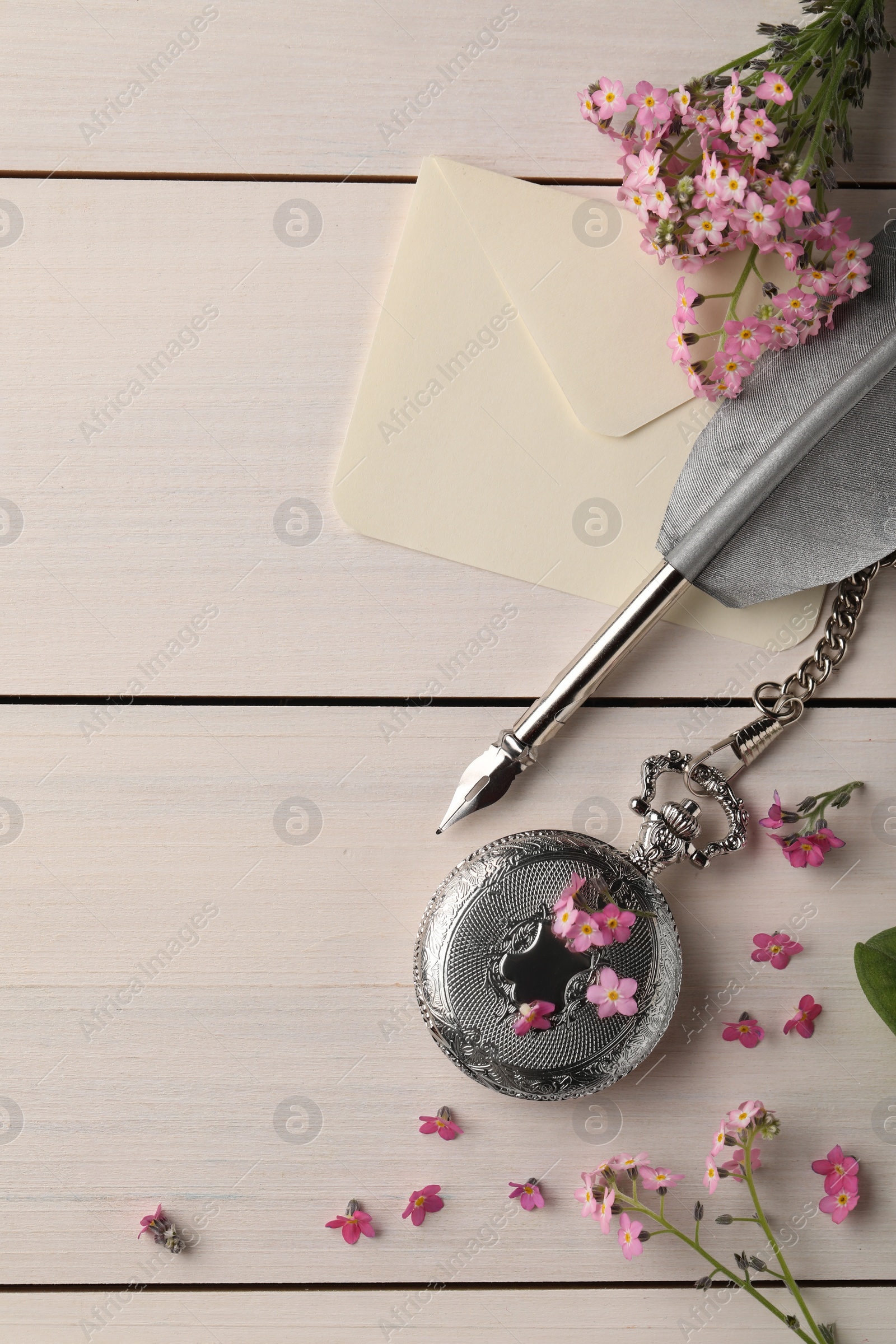 Photo of Flat lay composition with beautiful Forget-me-not flowers on white wooden table