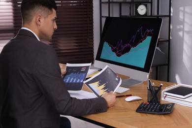 Businessman working with computer and graph in office. Forex trading