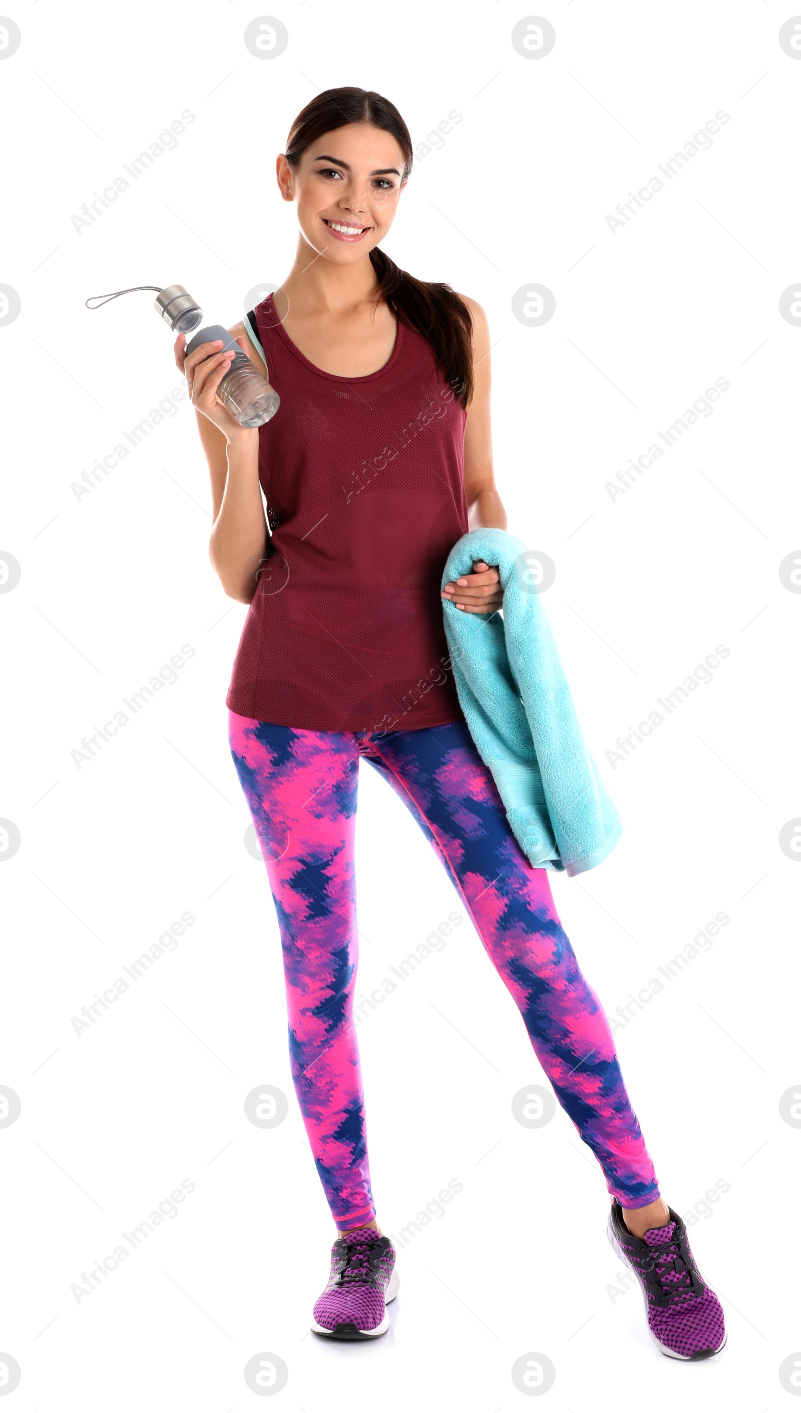 Photo of Beautiful young woman in sportswear with towel and bottle of water on white background