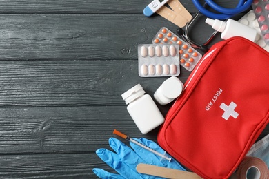 Photo of Flat lay composition with first aid kit and space for text on dark background