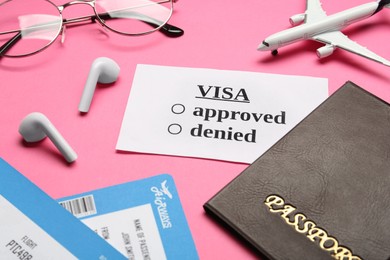 Photo of Composition with passport, toy plane and tickets on pink background. Receiving visa