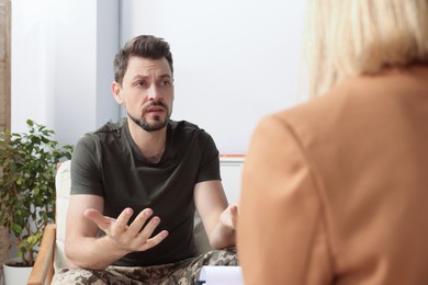 Psychologist working with military officer in office