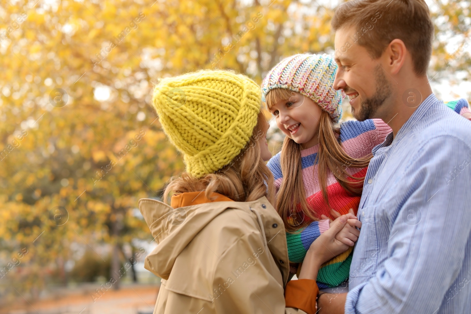 Photo of Happy family with child together in park. Autumn walk