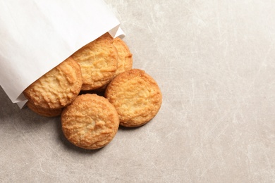 Photo of Paper bag with Danish butter cookies on grey background, top view. Space for text