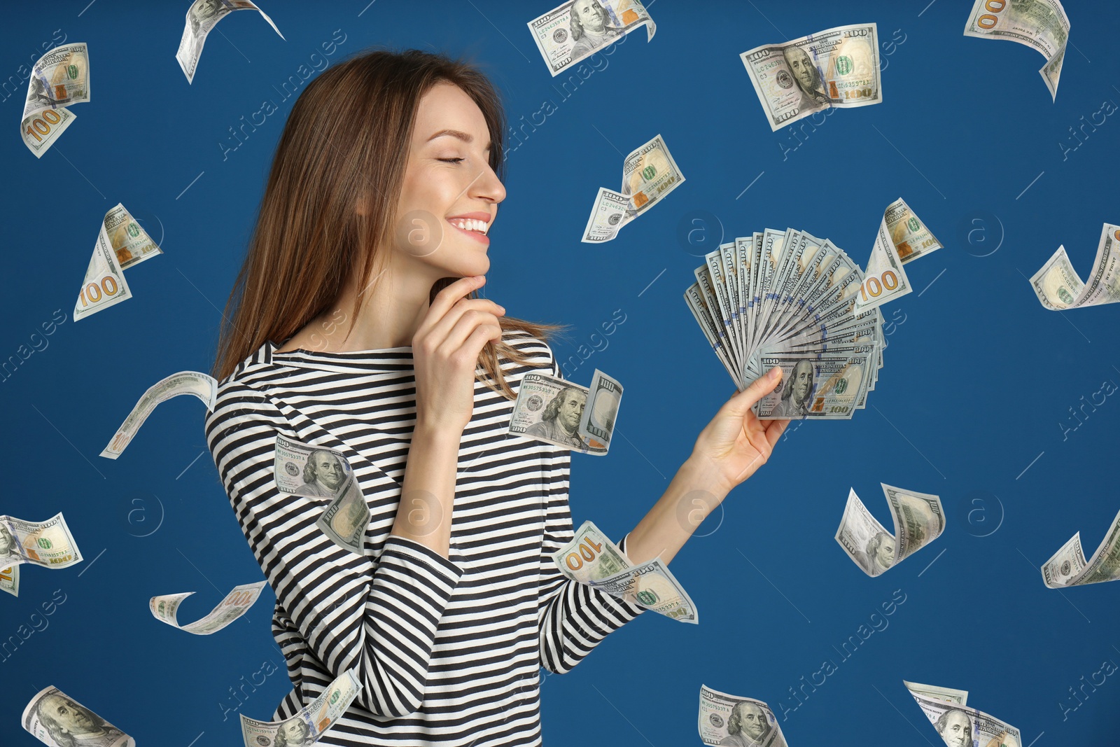 Image of Woman with American dollars under money rain on blue background