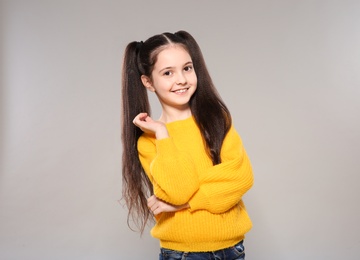 Photo of Portrait of little girl posing on grey background