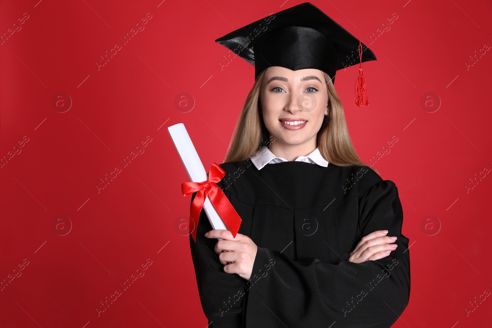 Photo of Happy student with diploma on red background