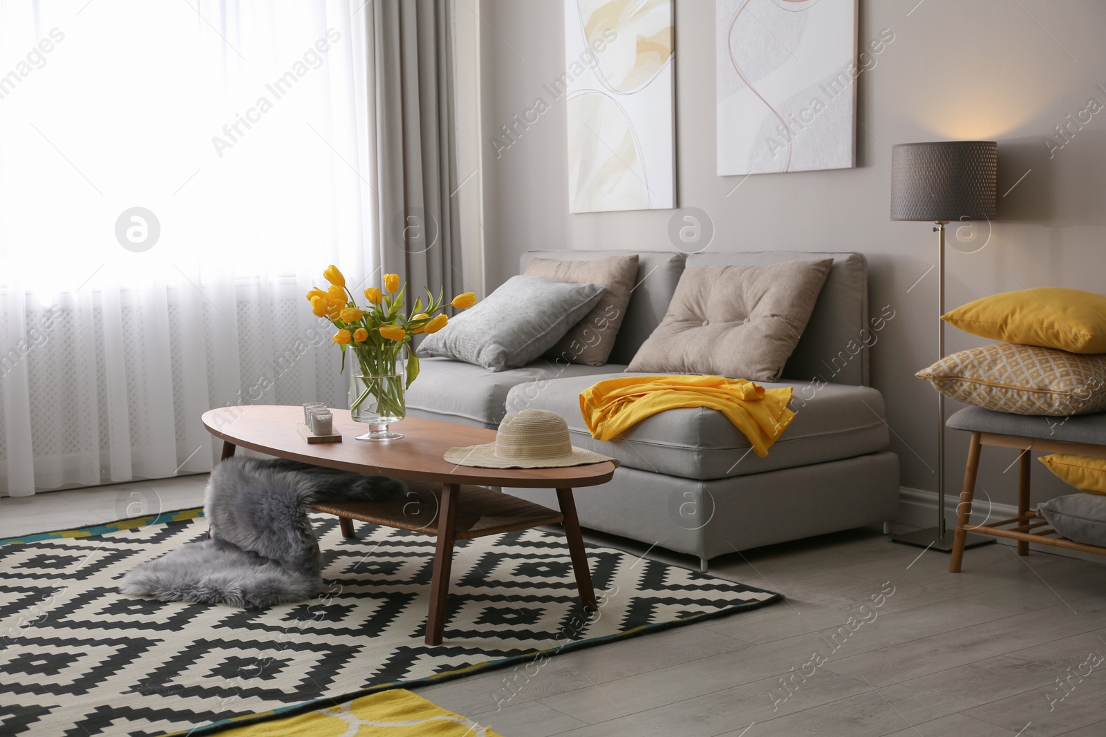 Photo of Stylish living room interior with comfortable sofa. Interior design in grey and yellow colors