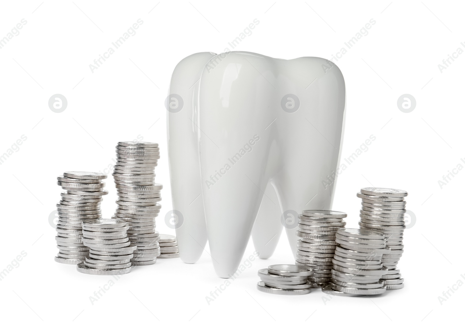 Photo of Ceramic model of tooth and coins on white background. Expensive treatment