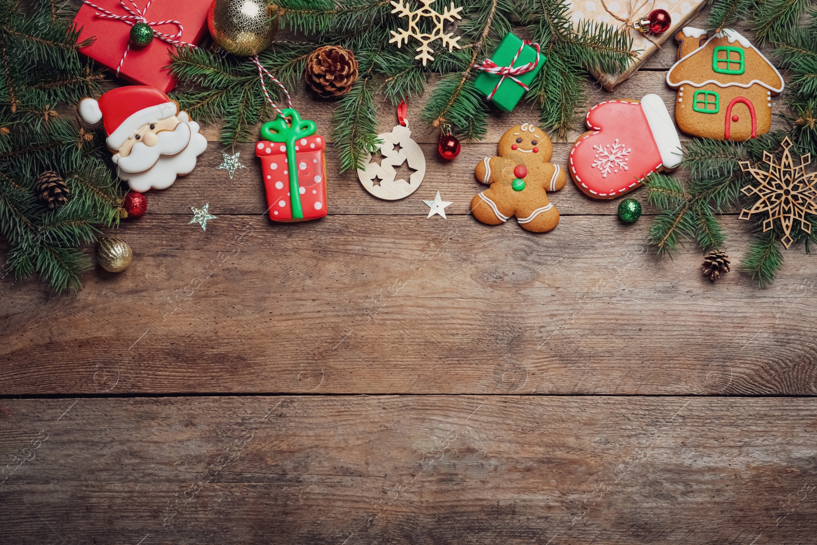 Photo of Flat lay composition with tasty Christmas cookies on wooden table, space for text