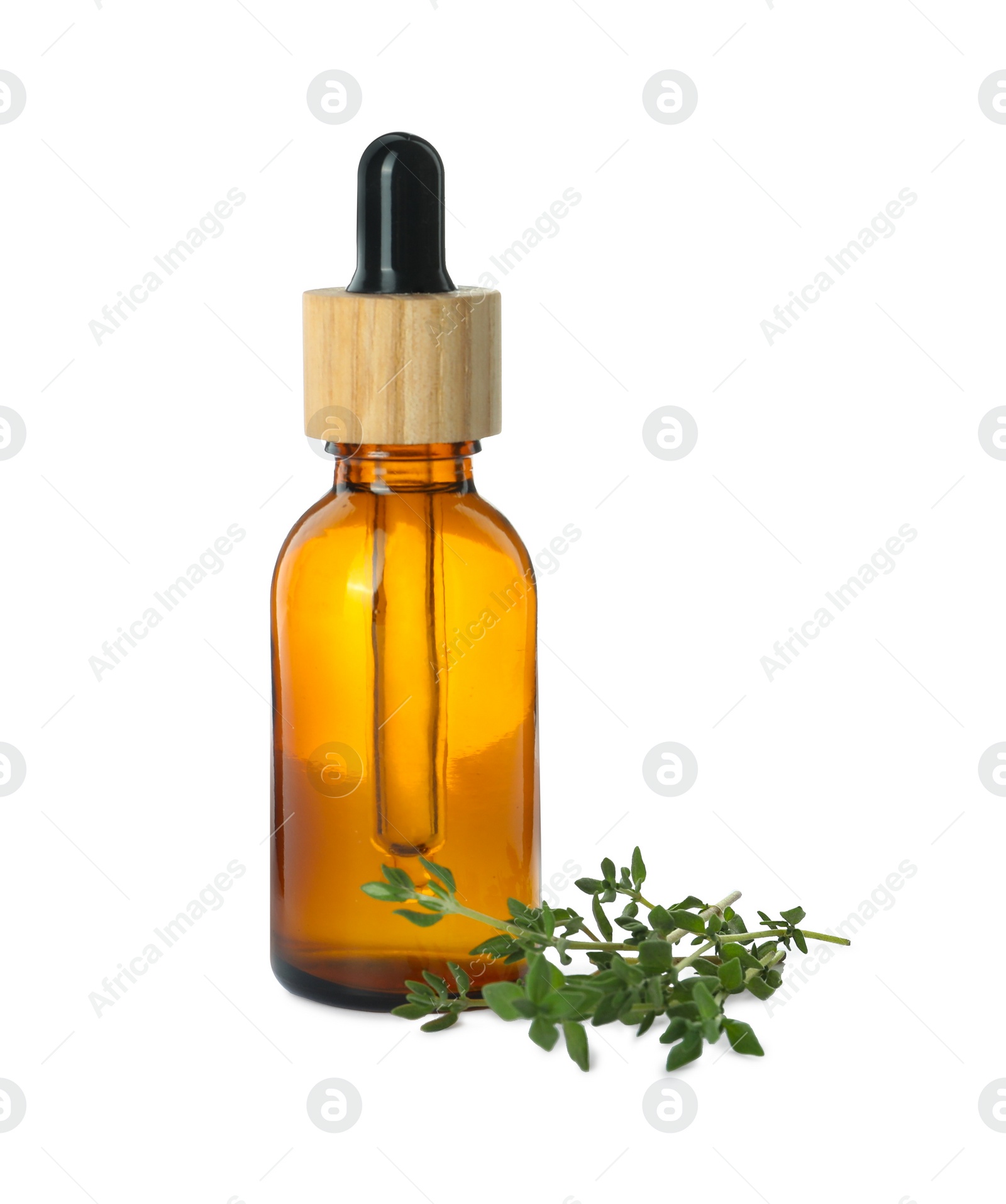 Photo of Bottle of essential oil and thyme isolated on white