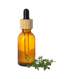 Photo of Bottle of essential oil and thyme isolated on white