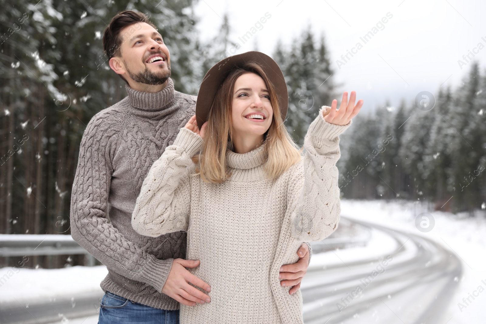 Photo of Cute couple outdoors on snowy day. Winter vacation