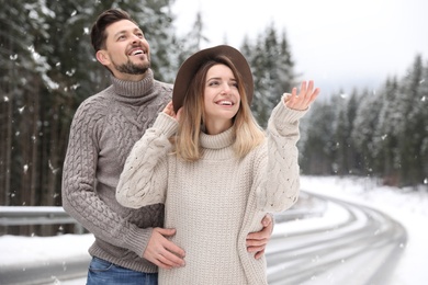 Cute couple outdoors on snowy day. Winter vacation