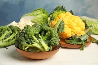 Different fresh cabbages on table. Healthy food