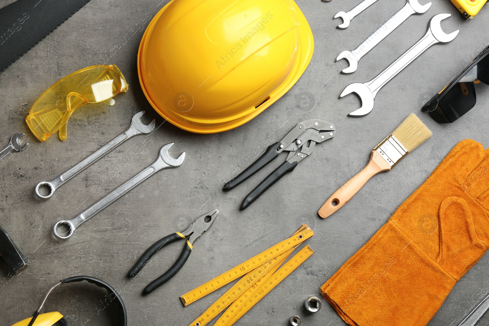 Photo of Flat lay composition with different construction tools on grey background