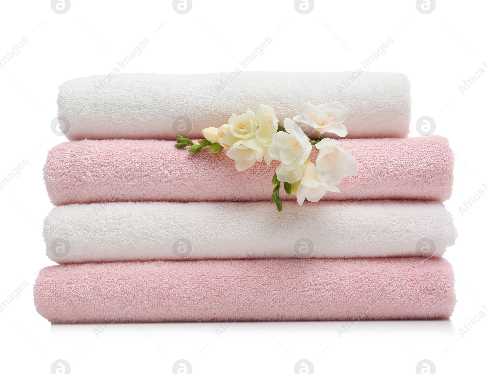 Photo of Stack of clean folded towels with flowers on white background