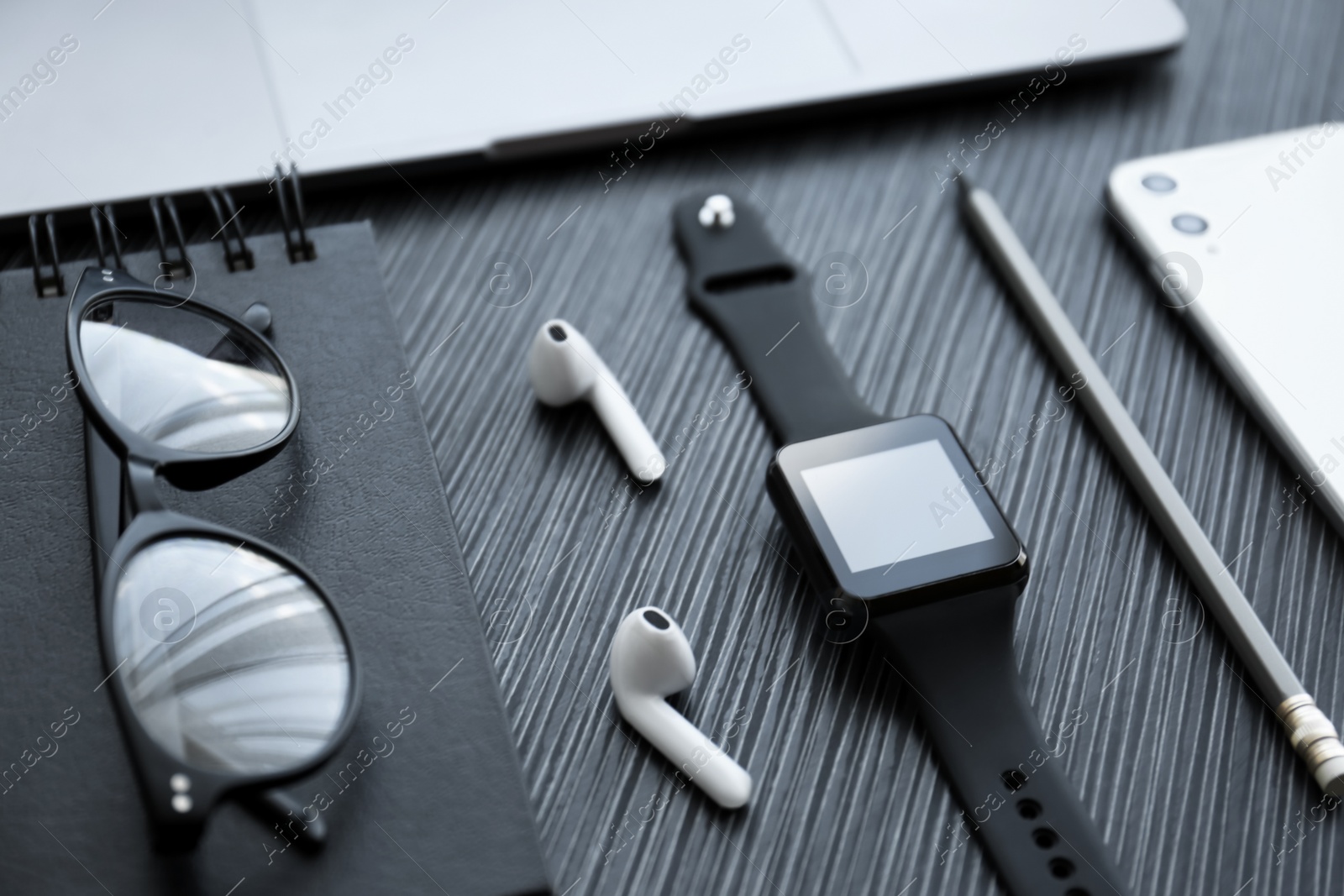 Composition with stylish smart watch on black table Photo of Composition with stylish smart watch on black table