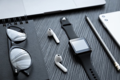 Photo of Composition with stylish smart watch on black table