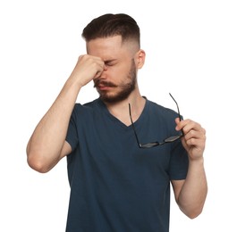Young man suffering from eyestrain on white background