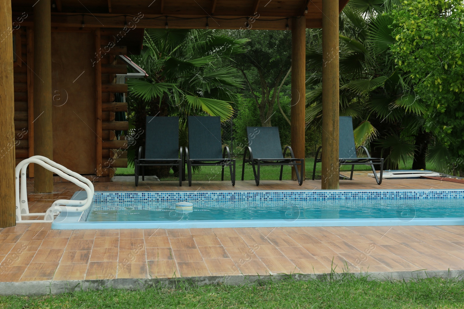 Photo of Outdoor swimming pool with clear water at resort