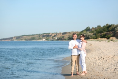 Photo of Happy mature couple at beach on sunny day