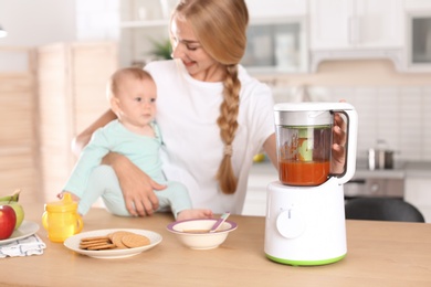 Photo of Woman preparing breakfast for her child in kitchen. Healthy baby food