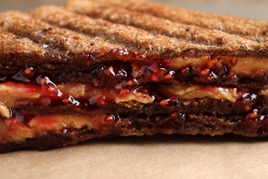 Image of Tasty sandwich with raspberry jam and peanut butter for breakfast, closeup