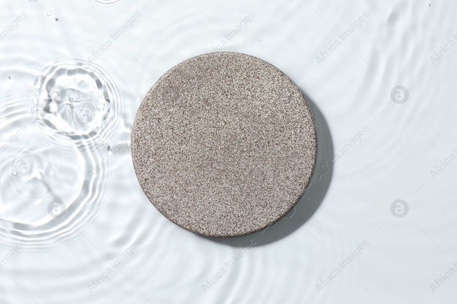 Photo of Presentation for product. Stone podium in water on white background, top view