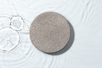 Photo of Presentation for product. Stone podium in water on white background, top view