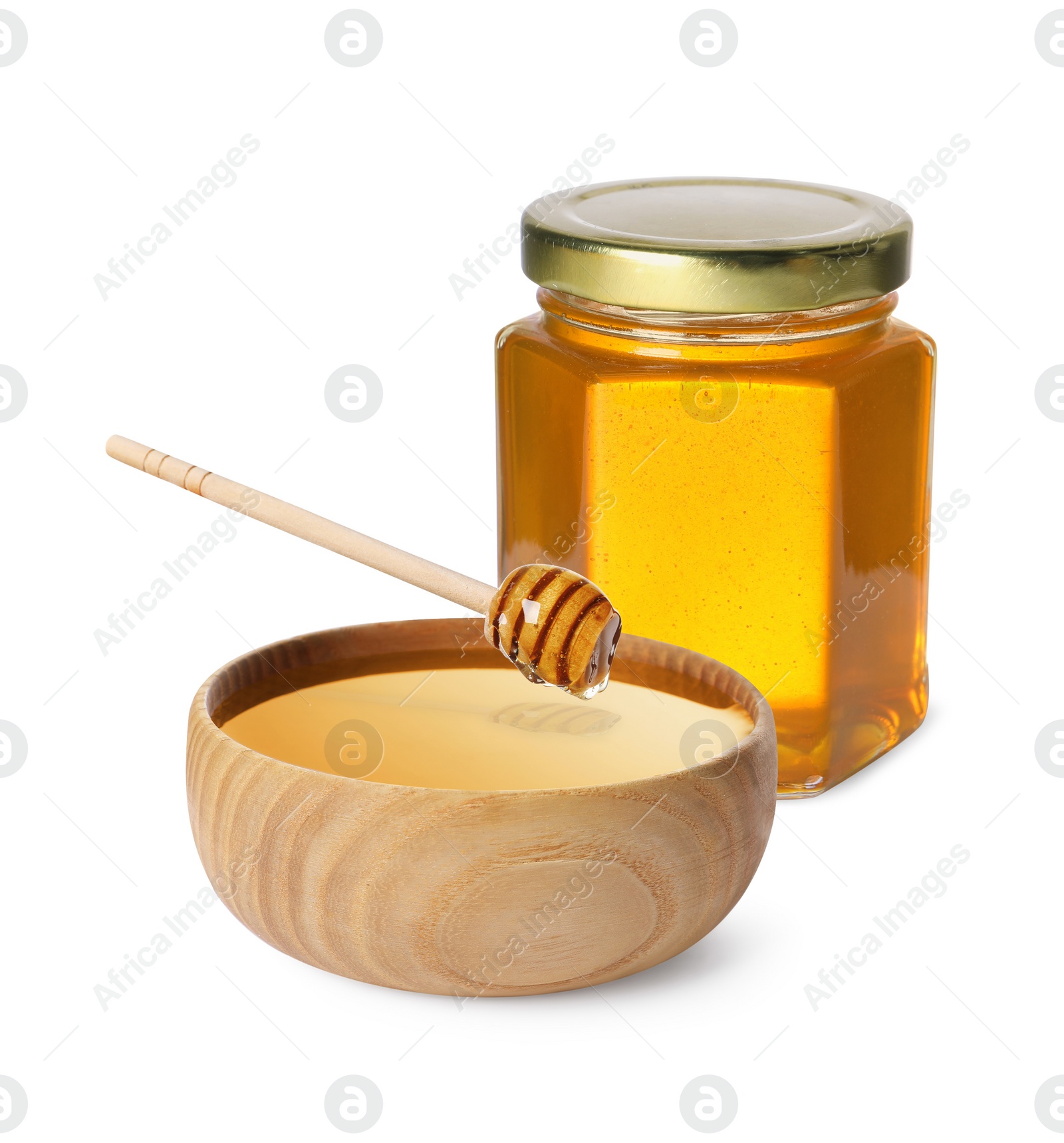 Image of Natural honey dripping from dipper into wooden bowl. Jar full of honey on white background