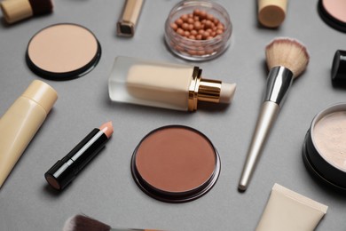 Photo of Face powders and other makeup products on grey background