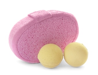 Photo of Pink sponge and bath bombs on white background