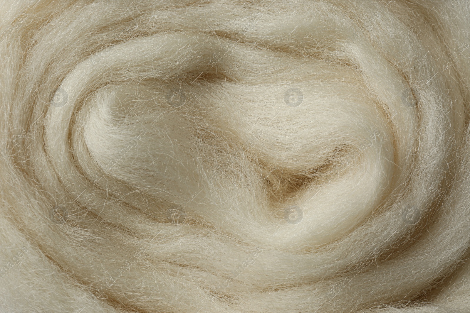 Photo of Combed white wool texture as background, closeup