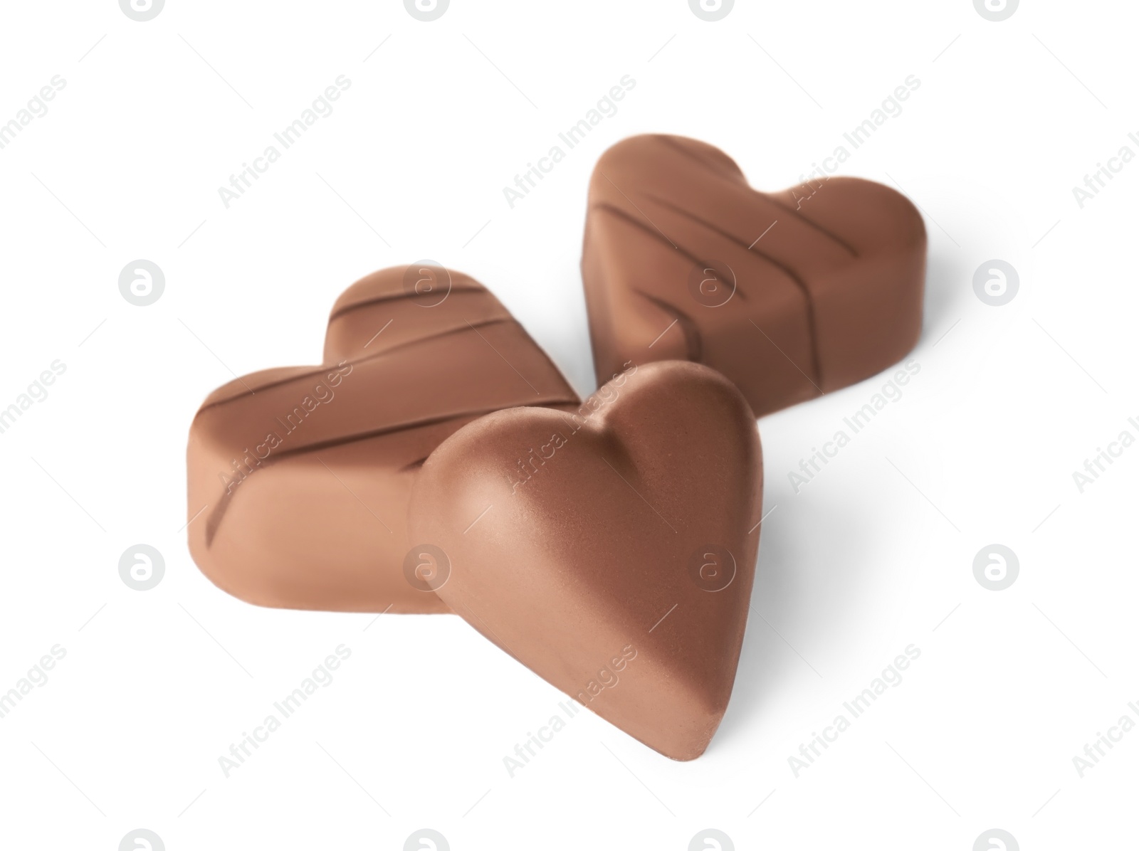 Photo of Tasty heart shaped chocolate candies on white background. Valentine's day celebration