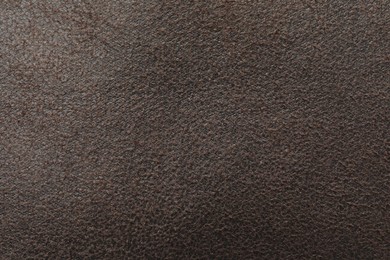 Photo of Texture of brown suede fabric as background, top view